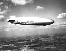 The maiden voyage of Akron on 2 November 1931, showing her four starboard propellers. The engines' water reclaiming devices appear as white strips above each propeller. The emergency rear control cabin is visible in the lower fin. USS Akron in flight, nov 1931.jpg