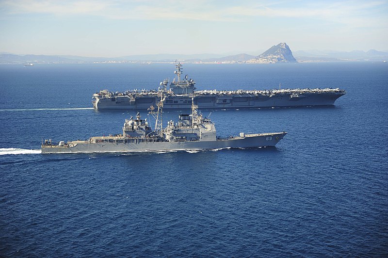 File:USS Vicksburg escorts USS Theodore Roosevelt past the Rock of Gibraltar. (17021946991).jpg