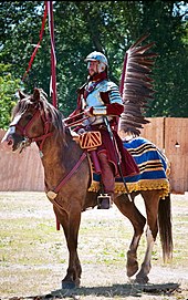 A historical re-enactor dressed in the Polish Winged Hussars armour Winged hussar, historical reconstruction.jpg