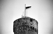 The blue-black-white flag of Estonia was raised again on the top of the Pikk Hermann tower on February 24, 1989. 24.02. kell 8.33. 1989 Toompeal (02).jpg