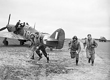 American pilots of No 71 'Eagle' Squadron rush to their Hawker Hurricanes at Kirton-in-Lindsey, 17 March 1941. CH2401.jpg