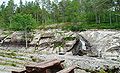 The upright figures on the south side of the rockface, with the reindeer to the left of the tree.