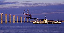 A bac and the bridge under construction, in 1987