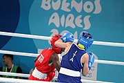 Deutsch: Boxen bei den Olympischen Jugendspielen 2018 Tag 12, 18. Oktober 2018 - Finale Fliegengewicht Mädchen – Martina La Piana (Italien, blau) schlägt Adijat Gbadamosi (Nigeria, rot) 5-0; Ringrichter ist James Beckles (Trinidad und Tobago). English: Boxing at the 2018 Summer Youth Olympics on 18 October 2018 – Girl's flyweight Gold Medal Bout - Martina La Piana (Italy, blue) beats Adijat Gbadamosi (Nigeria, red) 5-0; Referee is James Beckles (Trinidad and Tobago). Español: Boxeo en los Juegos Olímpicos Juveniles de Verano de 2018 en 18 de octubre de 2018 - Combate a medalla de oro de peso mosca para mujeres: Martina La Piana (Italia, azul) le gana a Adijat Gbadamosi (Nigeria, roja) 5-0; El árbitro es James Beckles (Trinidad y Tobago).