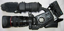 The Canon XL-H1 HDV camera, with a few accessories. Canon XLH1 HD Camera side view.jpg