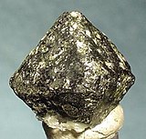 Octahedral chromite crystal from the Freetown Layered Complex in Sierra Leone, Africa (size: 1.3 x 1.2 x 1.2 cm)