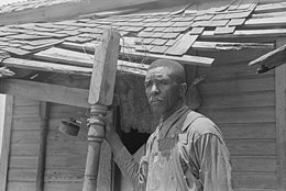 Tenant farmer on his front porch, south of Muskogee, Oklahoma (1939) Corbett Infobox (cropped).jpg