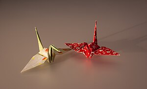 A red and a white paper crane.
