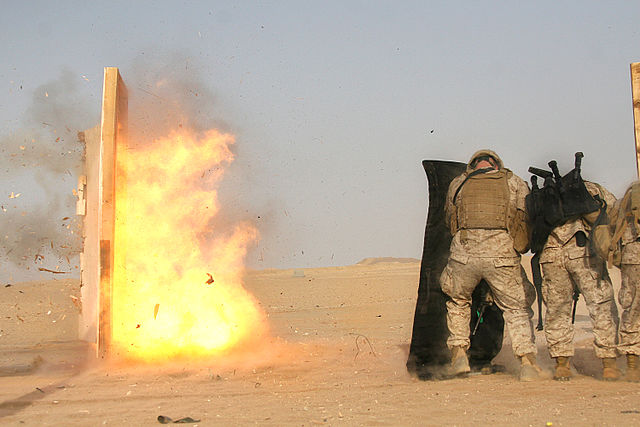 A breaching charge exploding against a test door during training