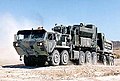 PLS M1075A0 truck laden with Engineer Mission Modules (EMM); M5 Concrete Mobile Mixer (EMM-CMM) on the truck, and M6 Dump Body (EMM-DB) on the M1076 trailer