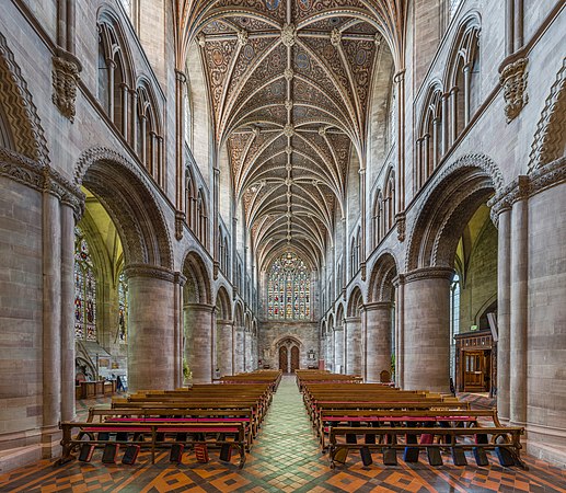 Hereford Cathedral's nave looking towards the western entrance and stained glass windows, viewed from the east