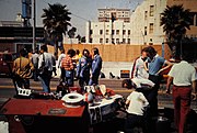 John Watson and Ronnie Peterson, talking to each other in the Penske pitwall at the 1976 United States Grand Prix West