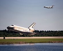 An STA flying above Discovery as it lands at the conclusion of STS-95 in 1998 KSC-98EC-1565.jpg