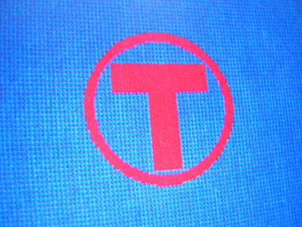 Metro Transit symbol on an old seat design on University Avenue