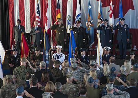 Attendees pays respects during the playing of the American national anthem at the NORAD-USNORTHCOM change of command ceremony on 23 May 2018.