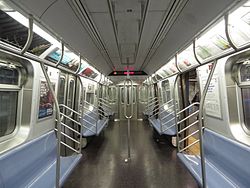 The interior of R160 car 9800 on the E line. This car is equipped with experimental looped stanchions