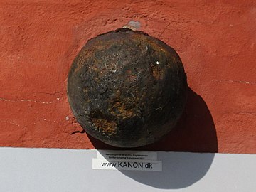 The cannonball embedded in the wall above the cellar entrance