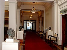 The door at right is an entrance to the Senate chamber from this corridor on the north-western side of King's Hall. The location of the House of Representatives chamber is mirrored on the opposite (south-eastern) side. OPH Senate entrance.jpg