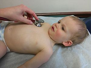 Physical exam of child with stethoscope on chest