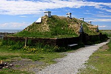 A reconstructed Norse hall with a grass sod roof