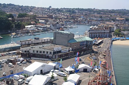 Weymouth Pier, with the rear of Weymouth Pavilion and Weymouth Harbour seen during the Summer 2012 Olympics. The Pavilion and Weymouth Harbour.jpg