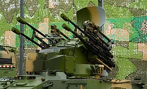 Four QW-2 missiles (brown) on the tower of a PGZ95