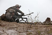 A U.S. Military Soldier initiating a barrel change of the M240.