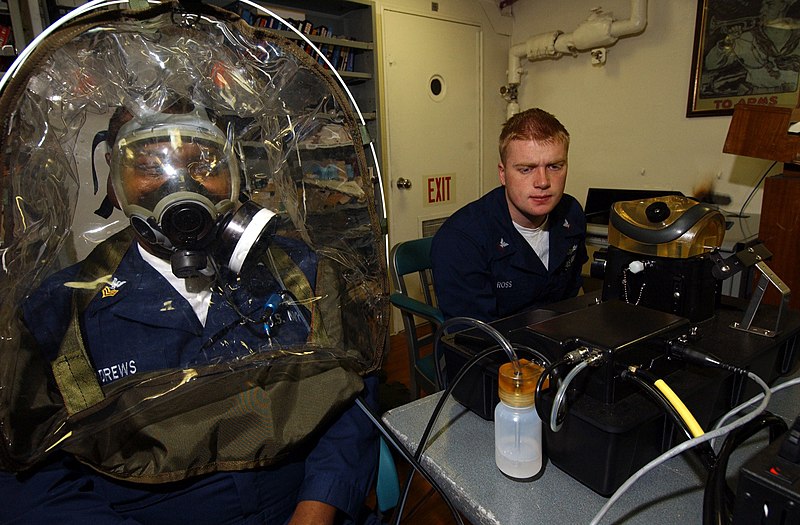 File:US Navy 040202-N-9288T-045 Fire Controlman 1st Class Ritchie Andrews, of Laurelton, N.Y., has a fit test performed on his MCU-2-P gas mask while Damage Controlman 3rd Class Travis Ross, from Delavan, Wis., monitors the readings.jpg