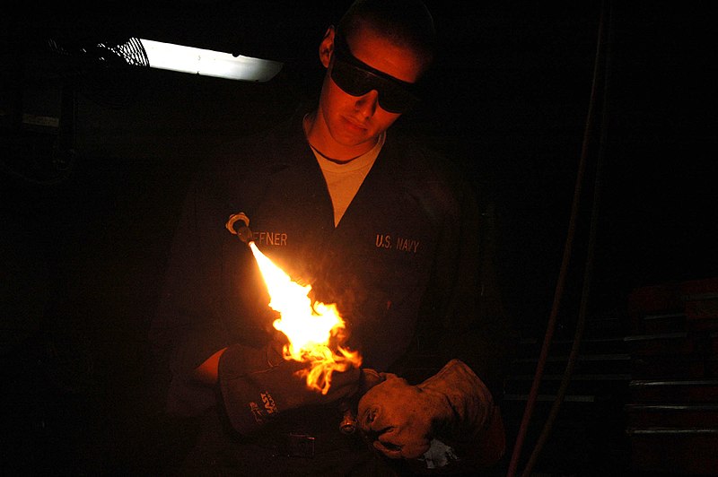 File:US Navy 070413-N-2943C-001 Hull Technician Fireman Troy Heffner lights up an oxygen acetyl torch prior to a welding job in the hull technician shop.jpg
