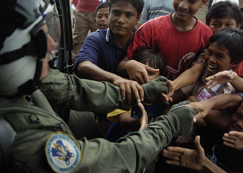 File:US Navy aircrewman assigned to Helicopter Anti-Submarine Squadron 2 shakes the hands of local citizens following the 2004 tsunami - Defense.gov News Photo 050106-N-6817C-470.jpg