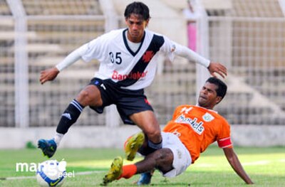 Wilton Gomes of Sporting Clube de Goa tackles Lester Fernandes of Vasco SC during a 2008–09 I-League match at Fatorda Stadium