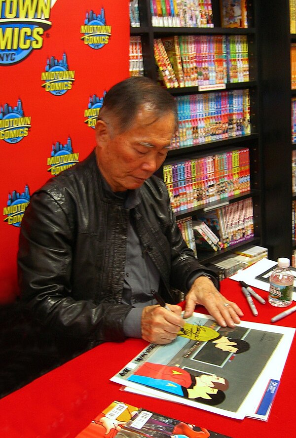 Actor George Takei autographing an original animation cel from the series at Midtown Comics in Manhattan.