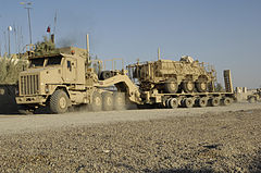 An Oshkosh M1070A0 and a DRS M1000 semi-trailer carrying a M93 Fox NBC detection vehicle