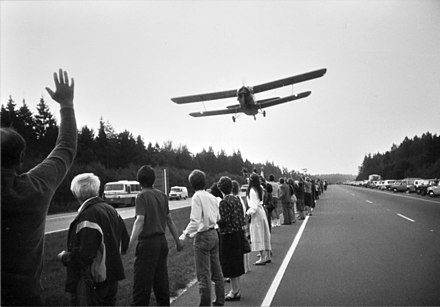Airplane flying over the human chain