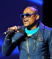 apl.de.ap holding a handheld microphoone