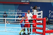 Deutsch: Boxen bei den Olympischen Jugendspielen 2018 Tag 12, 18. Oktober 2018 - Finale Fliegengewicht Mädchen – Martina La Piana (Italien, blau) schlägt Adijat Gbadamosi (Nigeria, rot) 5-0; Ringrichter ist James Beckles (Trinidad und Tobago). English: Boxing at the 2018 Summer Youth Olympics on 18 October 2018 – Girl's flyweight Gold Medal Bout - Martina La Piana (Italy, blue) beats Adijat Gbadamosi (Nigeria, red) 5-0; Referee is James Beckles (Trinidad and Tobago). Español: Boxeo en los Juegos Olímpicos Juveniles de Verano de 2018 en 18 de octubre de 2018 - Combate a medalla de oro de peso mosca para mujeres: Martina La Piana (Italia, azul) le gana a Adijat Gbadamosi (Nigeria, roja) 5-0; El árbitro es James Beckles (Trinidad y Tobago).