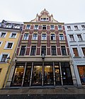 Apartment building in closed development, with shop with original front