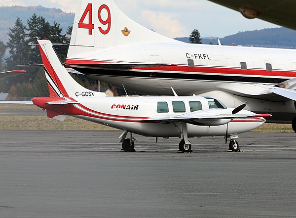 Piper Aerostar "bird dog" parked beside a Convair 580 air tanker