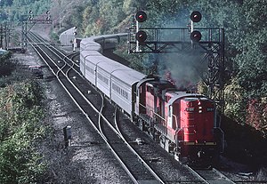 CN 3151 RS18m wih a train of Hawker Siddeley Tempo cars at Bayview Jct., on the outskirts of Hamilton, Ontario, eastbound off the Dundas Sub. onto the Oakville Sub. in October 1981 (34125077603).jpg