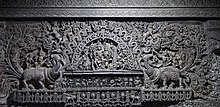 Celestial deity with mythical animals carved at the entrance Chennakesava Temple- carvings on outer wall.jpg