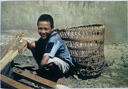 Chinese boy carrying a bamboo basket (before 1945)