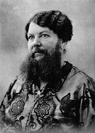 A black and white photography of Clémentine Delait. She is wearing a top ornated with flowers. Her beard is long enough to completely cover her throat.