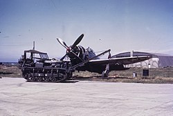 Cletrac in front of a P-47 Thunderbolt of the 406th Fighter Group Cletrac and P-47.jpg