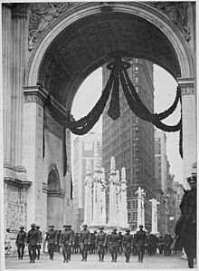 A 1919 image of the 165th Infantry Regiment passing through Madison Square's Victory Arch. The Flatiron Building is in the background.