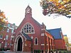 The red brick facade of a church.