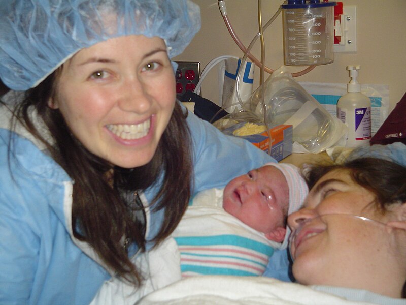 File:Doula (L) with newborn and mother.jpg