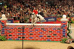 Ellen Whitaker with Ladina B at the Accenture puissance at 2008 Olympia London International Horse Show Ellen whitaker.jpg