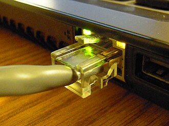A twisted pair cable with an 8P8C modular connector attached to a laptop computer, used for Ethernet Ethernet Connection.jpg