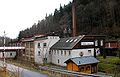 Factory building of a wood goods factory, with factory chimney