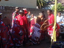 An initiate (ithwasa) being led towards the goat that will be sacrificed at her initiation into becoming a sangoma Goat Sacrifice at Thwasa Initiation.jpg